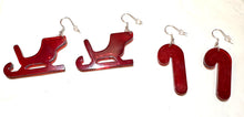 Load image into Gallery viewer, Red sleigh and candy cane earrings on a white background