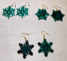 Load image into Gallery viewer, Set of snowflake-shaped earrings in green and black on a white background