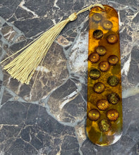 Load image into Gallery viewer, Decorative bookmark with gold tassel and circular embellishments on a marble surface