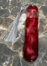 Load image into Gallery viewer, Red marbled bookmark with a silver tassel on a marble surface