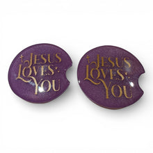 Load image into Gallery viewer, Two purple car coasters with 'Jesus Loves You' text on a white background