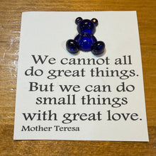 Load image into Gallery viewer, Blue glass bear on a card with a Mother Teresa quote on a wooden surface