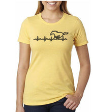 Load image into Gallery viewer, Yellow t-shirt with a horse and heartbeat design worn by a person on a white background