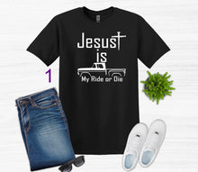 Load image into Gallery viewer, Black t-shirt with 'Jesus is my ride or die' graphic, paired with jeans, sneakers, and sunglasses on a white background.