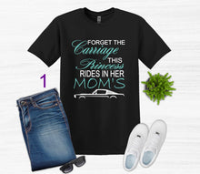 Load image into Gallery viewer, Black t-shirt with Forget the Carriage this Princess rides in her Mom's Mustang  text, blue jeans, white sneakers, and sunglasses on a light gray background.
