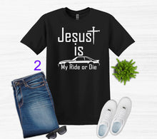 Load image into Gallery viewer, Black t-shirt with 'Jesus is my ride or die' text, paired with jeans, sneakers, and sunglasses on a white background.