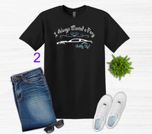 Load image into Gallery viewer, Black t-shirt with graphic design, blue jeans, white sneakers, sunglasses, and a plant on a light gray background