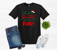 Load image into Gallery viewer, Black t-shirt with 'Dear Santa It Was My Bunny' text, jeans, white sneakers, sunglasses on a light gray background