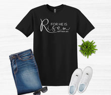 Load image into Gallery viewer, Black t-shirt with 'For He is Risen' text, jeans, white sneakers, and sunglasses on a white background.