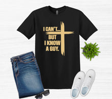 Load image into Gallery viewer, Black t-shirt with gold text I can't buy I know a guy cross, blue jeans, white sneakers, and sunglasses on a light gray background.