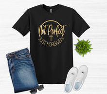 Load image into Gallery viewer, Black t-shirt with gold text not perfect just forgiven with cross, blue jeans, white sneakers, sunglasses, and a small plant on a light gray background