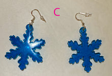 Load image into Gallery viewer, Blue snowflake earrings on a light gray background