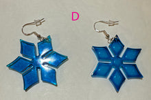 Load image into Gallery viewer, Blue star-shaped earrings on a light gray background