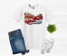 Load image into Gallery viewer, A white graphic t-shirt featuring a 'Merry Stangmas' holiday design with a red muscle car and reindeer, styled in a flat lay with blue jeans, white sneakers, sunglasses, and a small green plant on a white wood-textured background.