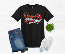 Load image into Gallery viewer, A black graphic t-shirt featuring a red snowmobile and Santa Claus with the text 'Merry Stangmas' in stylized lettering. The t-shirt is displayed in a flat-lay arrangement alongside folded blue jeans, white sneakers, sunglasses, and a small green plant on a white wood-textured background.