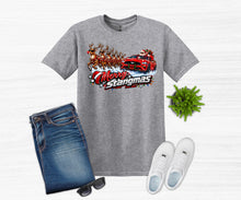Load image into Gallery viewer, A heather gray graphic t-shirt featuring a 'Merry Stangmas' Santa Claus in a red muscle car with reindeer design, styled in a flat lay with blue jeans, white sneakers, sunglasses, and a small green plant on a white wood background.