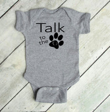 Load image into Gallery viewer, Gray baby onesie with 'Talk to the Paw' text on a wooden floor