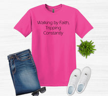Load image into Gallery viewer, Pink t-shirt with text, blue jeans, white sneakers, sunglasses, and a plant on a light gray background