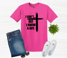 Load image into Gallery viewer, Pink t-shirt with I can't but I know a guy text with cross, jeans, white sneakers, and sunglasses on a white background