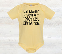 Load image into Gallery viewer, A pale yellow short-sleeve baby bodysuit with black printed text reading 'We Wof You a Merry Christmas' with paw prints and stars, displayed against a white wood plank background.