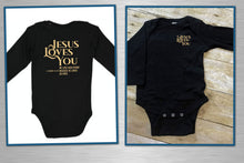 Load image into Gallery viewer, Black baby onesie with 'Jesus Loves You' text on a white and wooden background