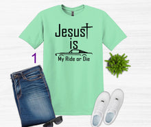 Load image into Gallery viewer, Mint green t-shirt with 'Jesus is My Ride or Die' text, paired with jeans, sneakers, and sunglasses on a white background.