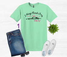 Load image into Gallery viewer, Mint green t-shirt with graphic design, blue jeans, white sneakers, sunglasses on a white background