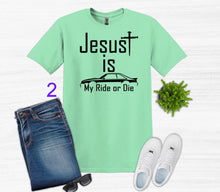Load image into Gallery viewer, Mint green t-shirt with 'Jesus is my ride or die' text, paired with jeans, sneakers, and sunglasses on a white background.