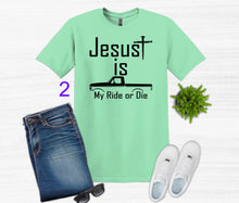 Load image into Gallery viewer, Mint green t-shirt with 'Jesus is my ride or die' text, paired with jeans, sneakers, and sunglasses on a white background.