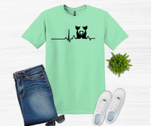 Load image into Gallery viewer, Mint green t-shirt with cat design, jeans, sneakers, and sunglasses on a white background