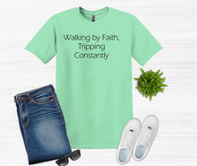 Load image into Gallery viewer, Mint green t-shirt with text, blue jeans, white sneakers, sunglasses, and a plant on a white background