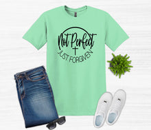 Load image into Gallery viewer, Mint green t-shirt with 'Not Perfect Just Forgiven' text, paired with jeans, sneakers, and sunglasses on a white background.