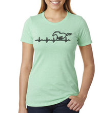 Load image into Gallery viewer, Person wearing a light green t-shirt with a black graphic design on a white background