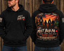 Load image into Gallery viewer, A man modeling a black pullover hoodie shown from both front and back against a rustic wooden plank background. The front features a small 'MEET BUB PA' graphic with a YouTube play button on the left chest.