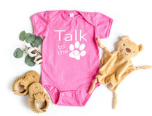 Load image into Gallery viewer, Pink baby onesie with 'Talk to the paw' text, surrounded by toys on a white background