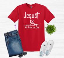 Load image into Gallery viewer, Red t-shirt with 'Jesus is my ride or die' text, paired with jeans, sneakers, sunglasses, and a plant on a white background.