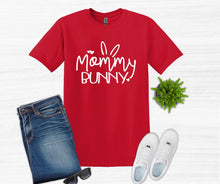 Load image into Gallery viewer, Red t-shirt with 'Mommy Bunny' text, blue jeans, white sneakers, and sunglasses on a light gray background.