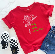 Load image into Gallery viewer, A red short-sleeve t-shirt with a white line-art ballerina graphic and the words 'Belle of the Ballet' in green script, styled flat-lay with black-and-white checkered slip-on shoes and blue jeans on a light marble surface.