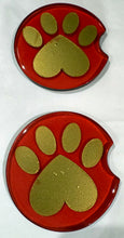 Load image into Gallery viewer, Two red car coasters with green paw prints on a white background