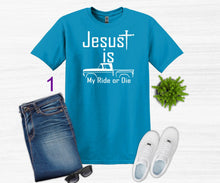 Load image into Gallery viewer, Blue t-shirt with 'Jesus is My Ride or Die' text, jeans, sneakers, and sunglasses on a white background
