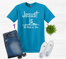 Load image into Gallery viewer, Blue t-shirt with 'Jesus is My Ride or Die' text, paired with jeans, sneakers, and sunglasses on a white background.