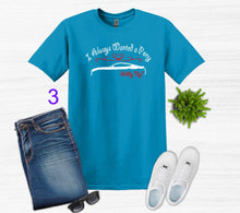 Load image into Gallery viewer, Blue t-shirt with graphic design, jeans, white sneakers, sunglasses on a light gray background