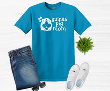 Load image into Gallery viewer, Blue t-shirt with 'guinea pig mom' text, jeans, white sneakers, and sunglasses on a white background
