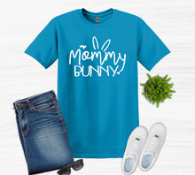 Load image into Gallery viewer, Blue t-shirt with 'Mommy Bunny' text, jeans, white sneakers, sunglasses on a light gray background