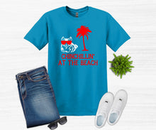 Load image into Gallery viewer, Blue t-shirt with 'Chinchillin' at the Beach' design, jeans, sunglasses, and white sneakers on a white background