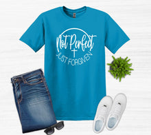Load image into Gallery viewer, Blue t-shirt with white text Not perfect just forgiven, jeans, white sneakers, sunglasses on a light gray background