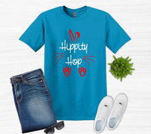 Load image into Gallery viewer, Blue t-shirt with 'Hippity Hop' text, jeans, white sneakers, and sunglasses on a white background