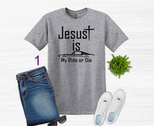 Load image into Gallery viewer, Gray t-shirt with 'Jesus is my ride or die' text, paired with jeans, sneakers, and a plant on a white background.