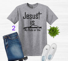 Load image into Gallery viewer, Gray t-shirt with 'Jesus is My Ride or Die' text, paired with jeans, sneakers, and sunglasses on a white background.