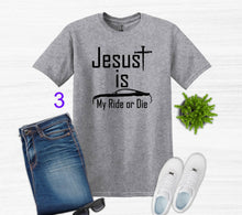 Load image into Gallery viewer, Gray t-shirt with 'Jesus is My Ride or Die' text, paired with jeans, sneakers, and sunglasses on a white background.